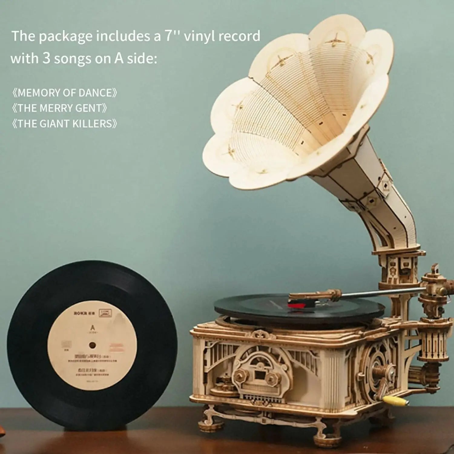 A decorative wooden gramophone model with a 7-inch vinyl record.