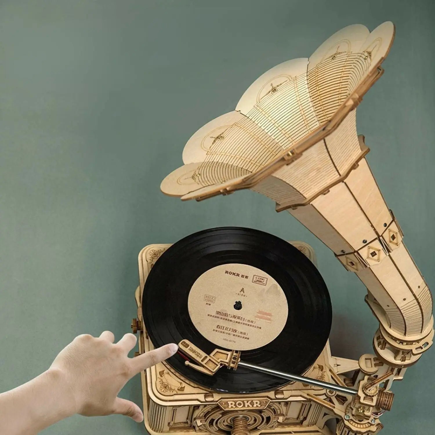 A wooden, self-assembly model of a vintage gramophone with a record player.
