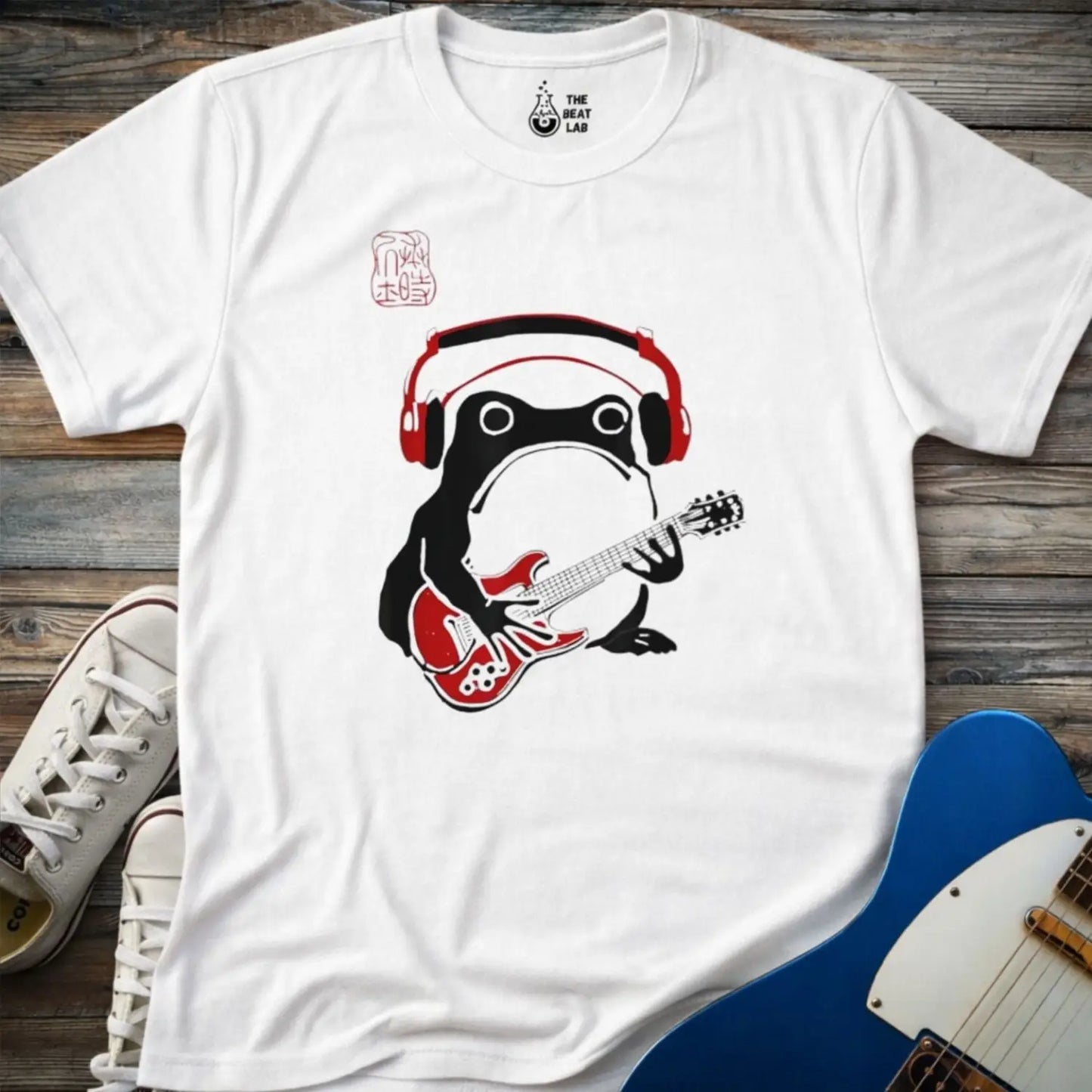 White color gildan 64000 adult men women shirt featuring Grumpy frog wearing red headphones and playing a red electric guitar graphic on a black t-shirt