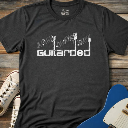 Dark heather grey adult men women gildan 64000 shirt featuring Distressed white “Guitarded” guitar pun design with guitar necks and music notes graphic on a black t-shirt