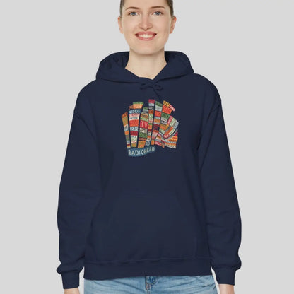 Adult woman wearing navy blue hoodie of Radiohead Hail to the Thief album featuring a bear-shaped block of colorful words and a RADIOHEAD label beneath.