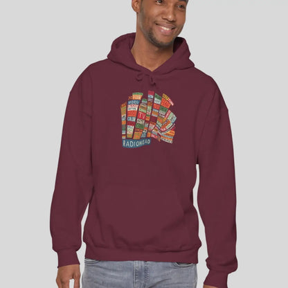 Adult man wearing maroon red hoodie of Radiohead Hail to the Thief album featuring a bear-shaped block of colorful words and a RADIOHEAD label beneath.