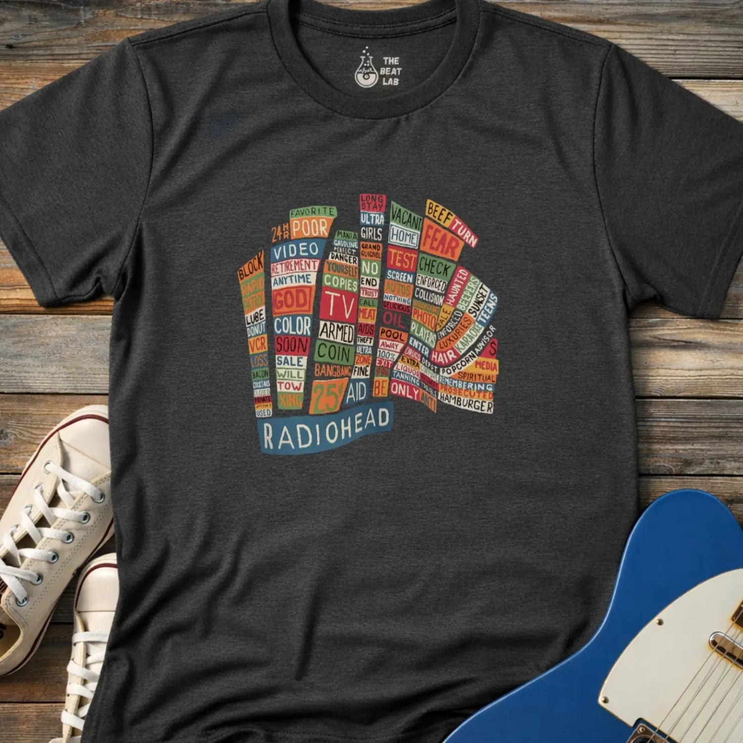 Dark Heather Grey color adult unisex t-shirt gildan 64000 Radiohead Hail to the Thief graphic t-shirt featuring a bear-shaped block of colorful words and a RADIOHEAD label beneath.