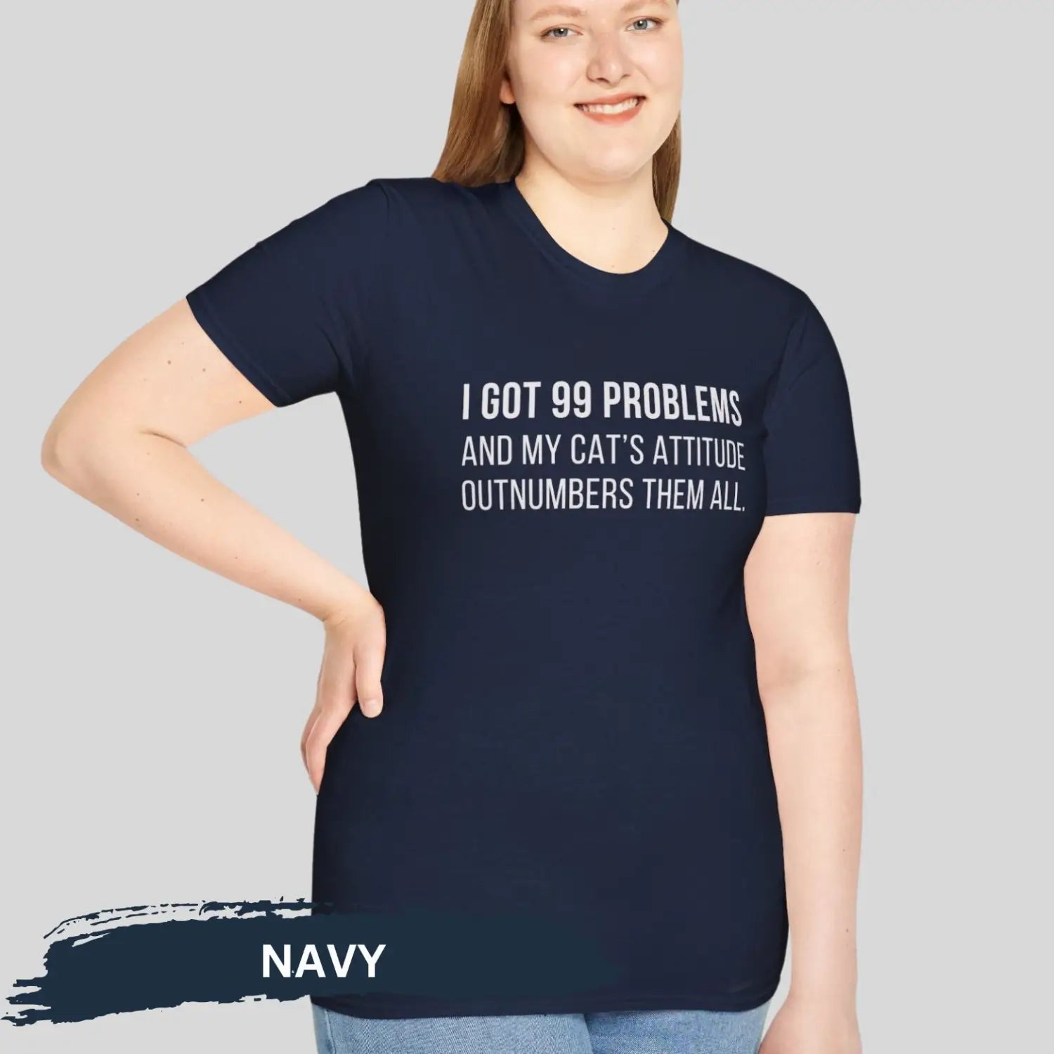 Adult woman wearing navy blue gildan 64000 unisex music shirt featuring jay z funny 99 problems graphic text "I got 99 problems and my cat’s attitude outnumbers them all".