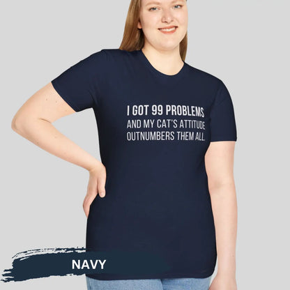 Adult woman wearing navy blue gildan 64000 unisex music shirt featuring jay z funny 99 problems graphic text "I got 99 problems and my cat’s attitude outnumbers them all".