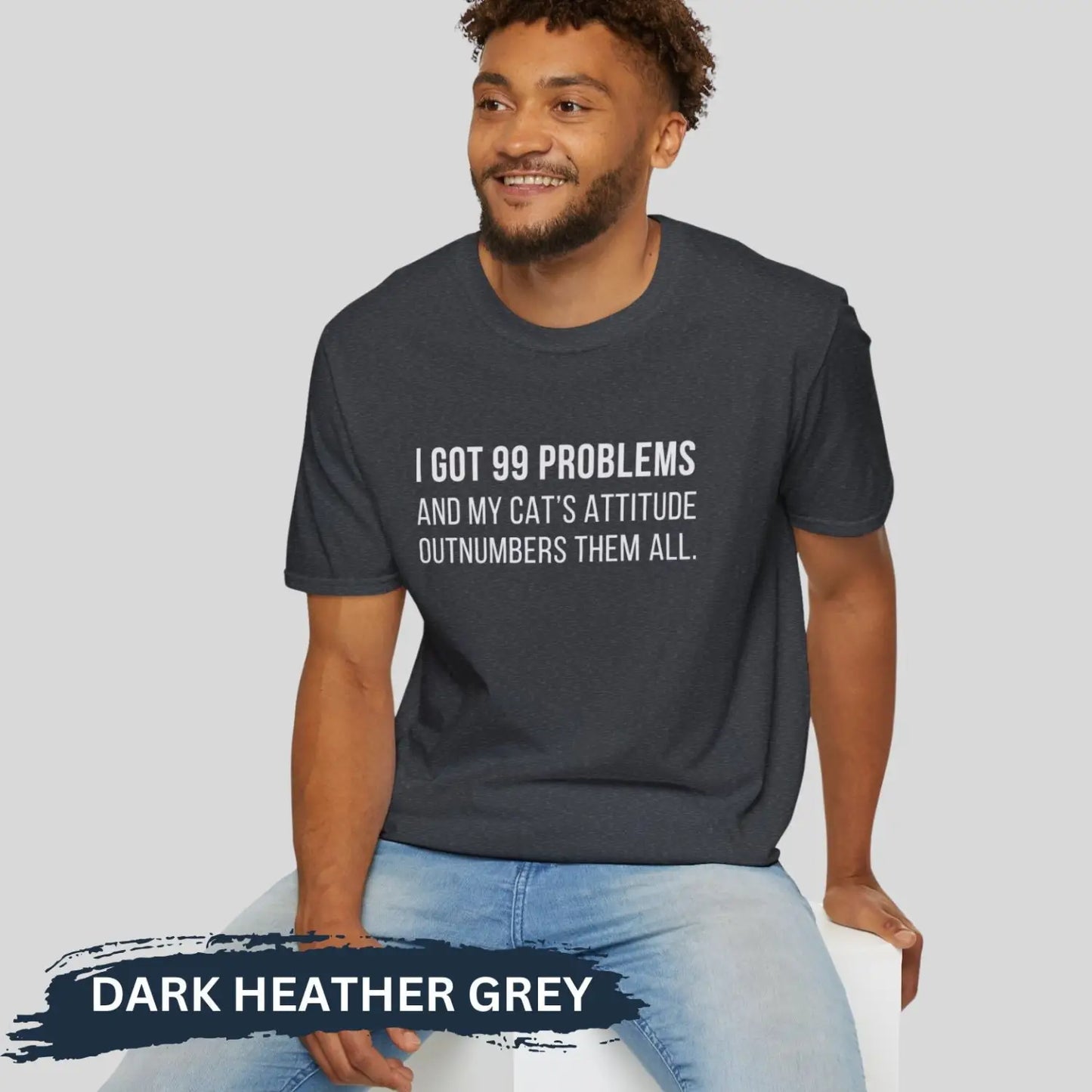 Adult man wearing dark heather grey gildan 64000 unisex music shirt featuring jay z funny 99 problems graphic text "I got 99 problems and my cat’s attitude outnumbers them all".