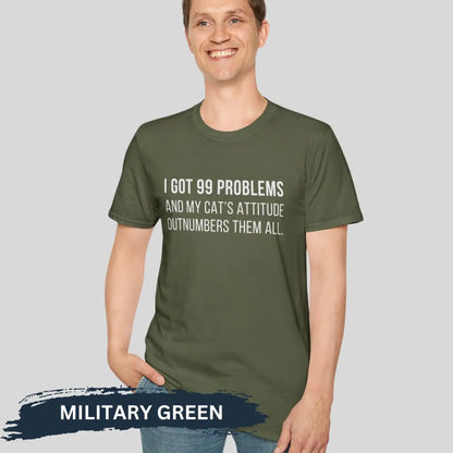 Adult man wearing military green gildan 64000 unisex music shirt featuring jay z funny 99 problems graphic text "I got 99 problems and my cat’s attitude outnumbers them all".