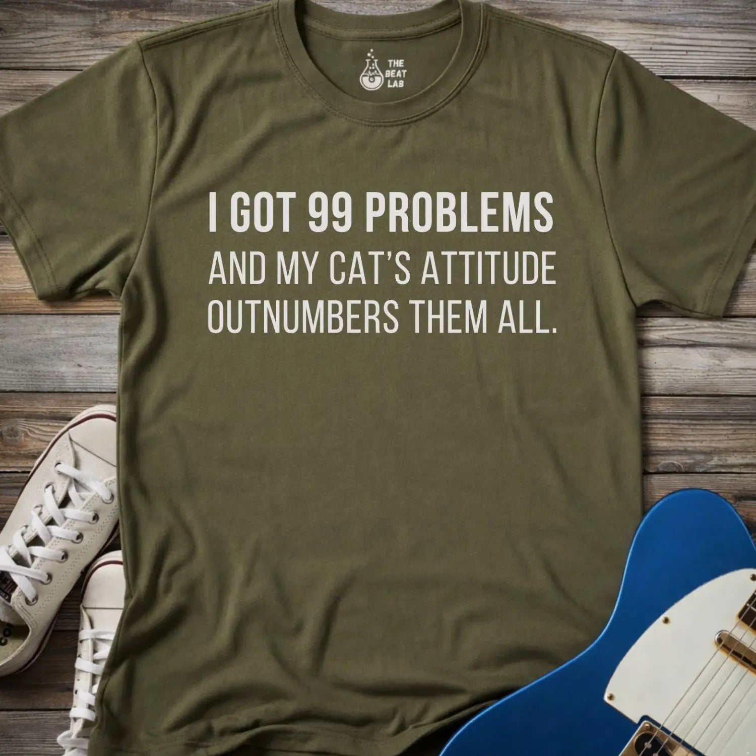 Military green color gildan 64000 unisex music shirt featuring jay z funny 99 problems graphic text "I got 99 problems and my cat’s attitude outnumbers them all".