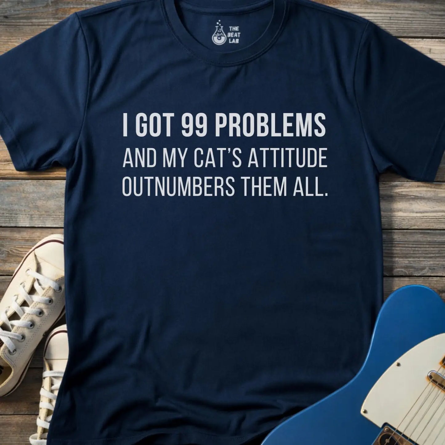 Navy color of gildan 64000 unisex music shirt featuring jay z funny 99 problems graphic text "I got 99 problems and my cat’s attitude outnumbers them all".