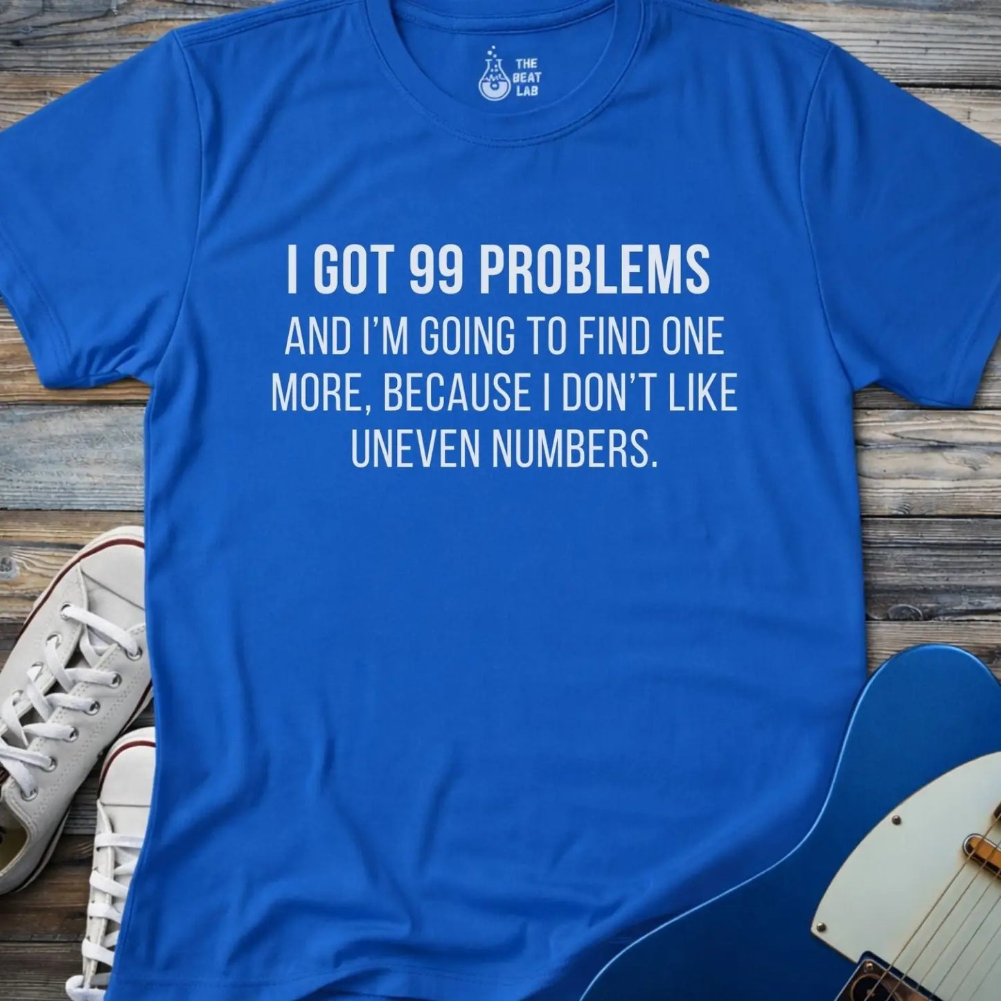 Royal blue gildan 64000 men women adult shirt with bold white text: “I got 99 problems and I’m going to find one more, because I don’t like uneven numbers” funny math humor design, funny Jay-z song 99 problems 