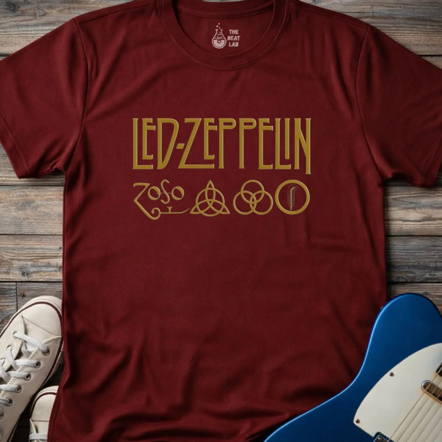 Maroon color adult unisex t-shirt gildan 64000 of Led Zeppelin Zoso symbols t-shirt with gold LED ZEPPELIN text and four iconic band symbols across the chest.