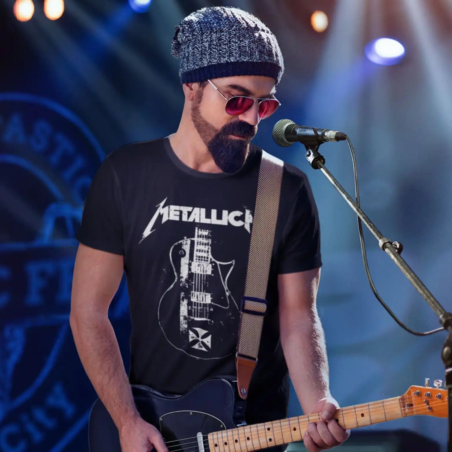 Man in Metallica t-shirt playing guitar.