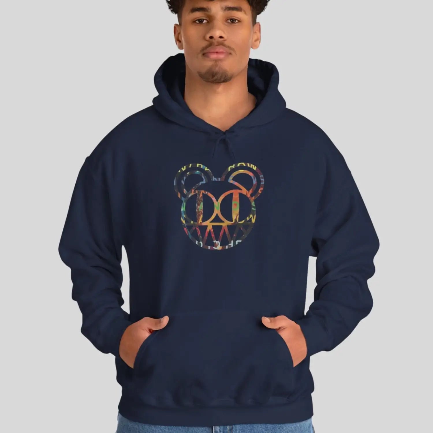 Man Person wearing a navy blue hoodie of Radiohead bear logo collage with the iconic cartoon bear head combined with colorful album-inspired artwork for rock fans