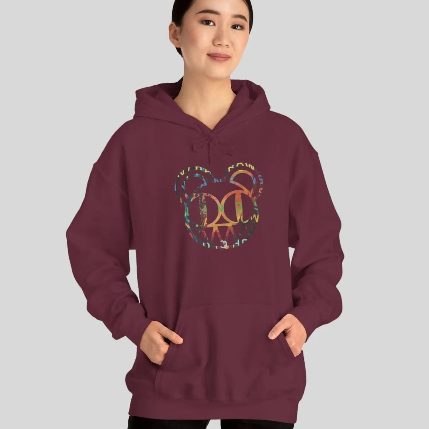 Woman Person wearing a maroon red hoodie of Radiohead bear logo collage with the iconic cartoon bear head combined with colorful album-inspired artwork for rock fans
