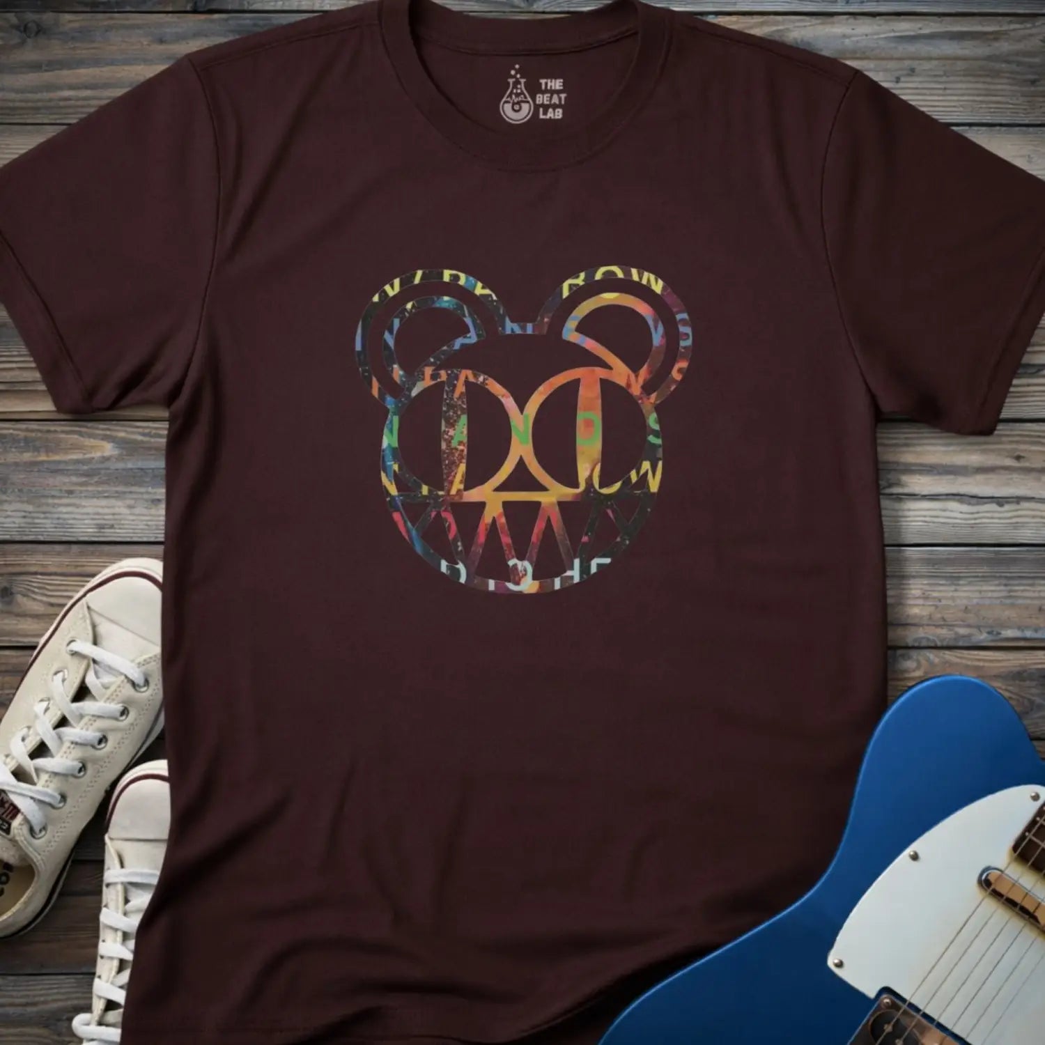 Dark chocolate unisex color Radiohead bear logo collage t-shirt with the iconic cartoon bear head combined with colorful album-inspired artwork for rock fans.
