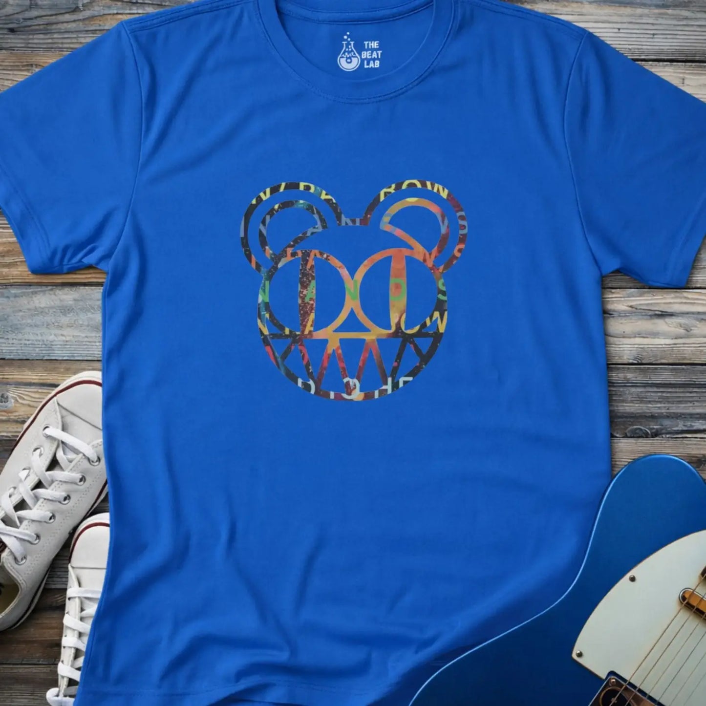 Royal blue unisex color Radiohead bear logo collage t-shirt with the iconic cartoon bear head combined with colorful album-inspired artwork for rock fans.