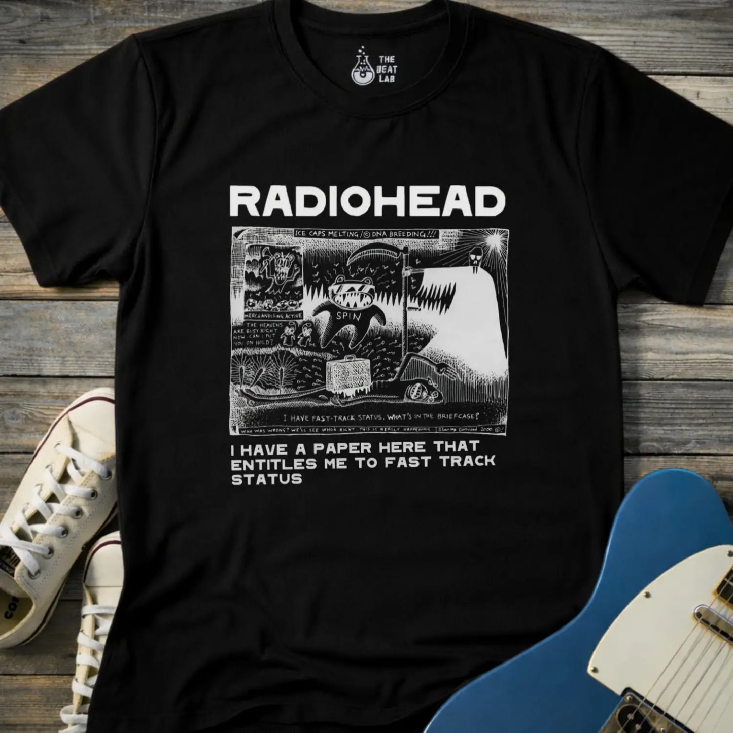 Black color of adult women men gildan 64000 shirt featuring radiohead fast track comic art, vintage bandwear music shirt
