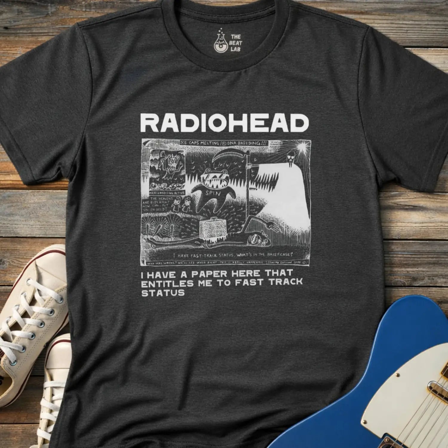 Dark heather grey color of adult women men gildan 64000 shirt featuring radiohead fast track comic art, vintage bandwear music shirt