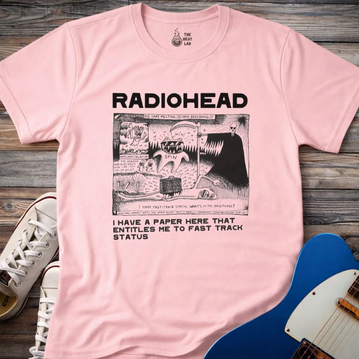 Light Pink color of adult women men gildan 64000 shirt featuring radiohead fast track comic art, vintage bandwear music shirt