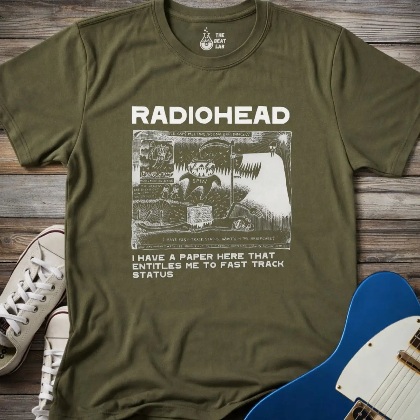 Military green color of adult women men gildan 64000 shirt featuring radiohead fast track comic art, vintage bandwear music shirt