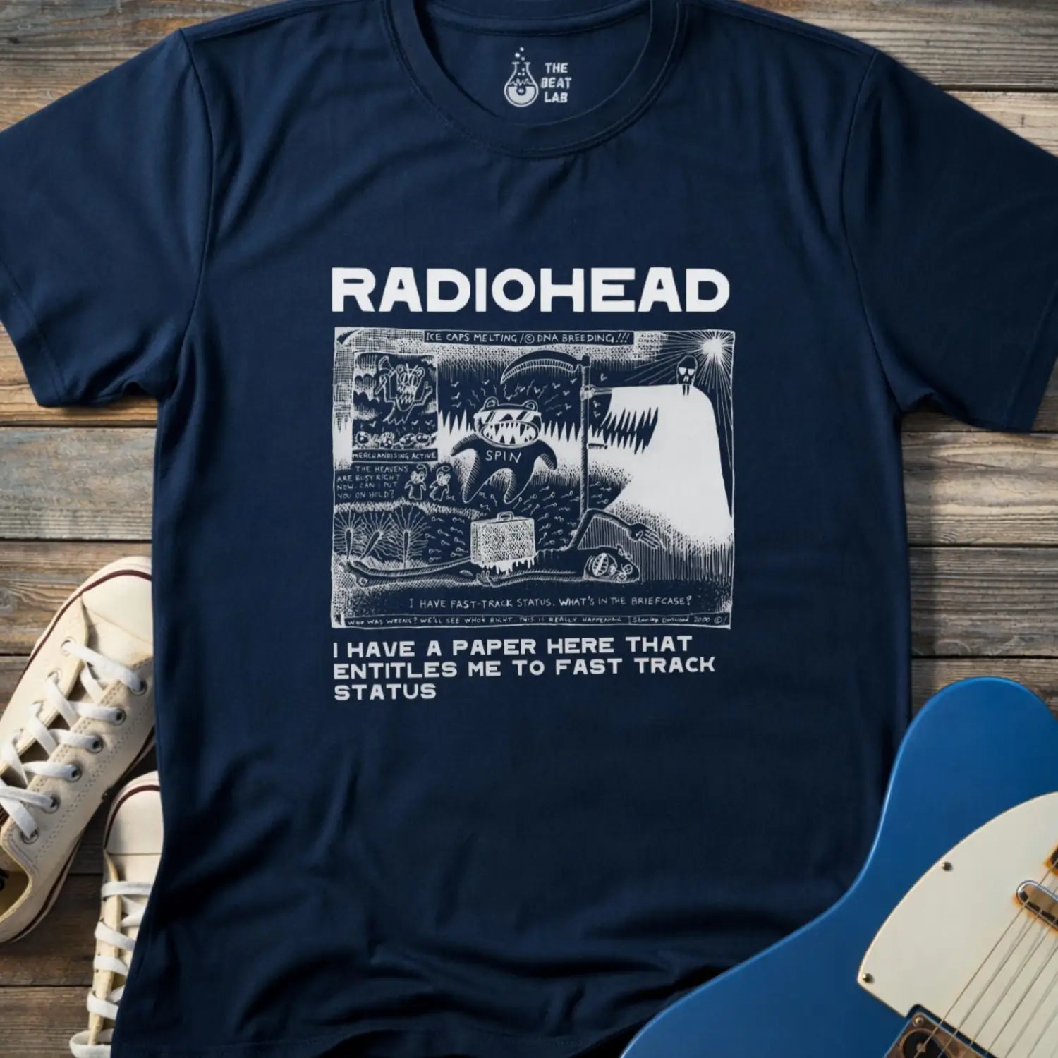 Navy blue color of adult women men gildan 64000 shirt featuring radiohead fast track comic art, vintage bandwear music shirt