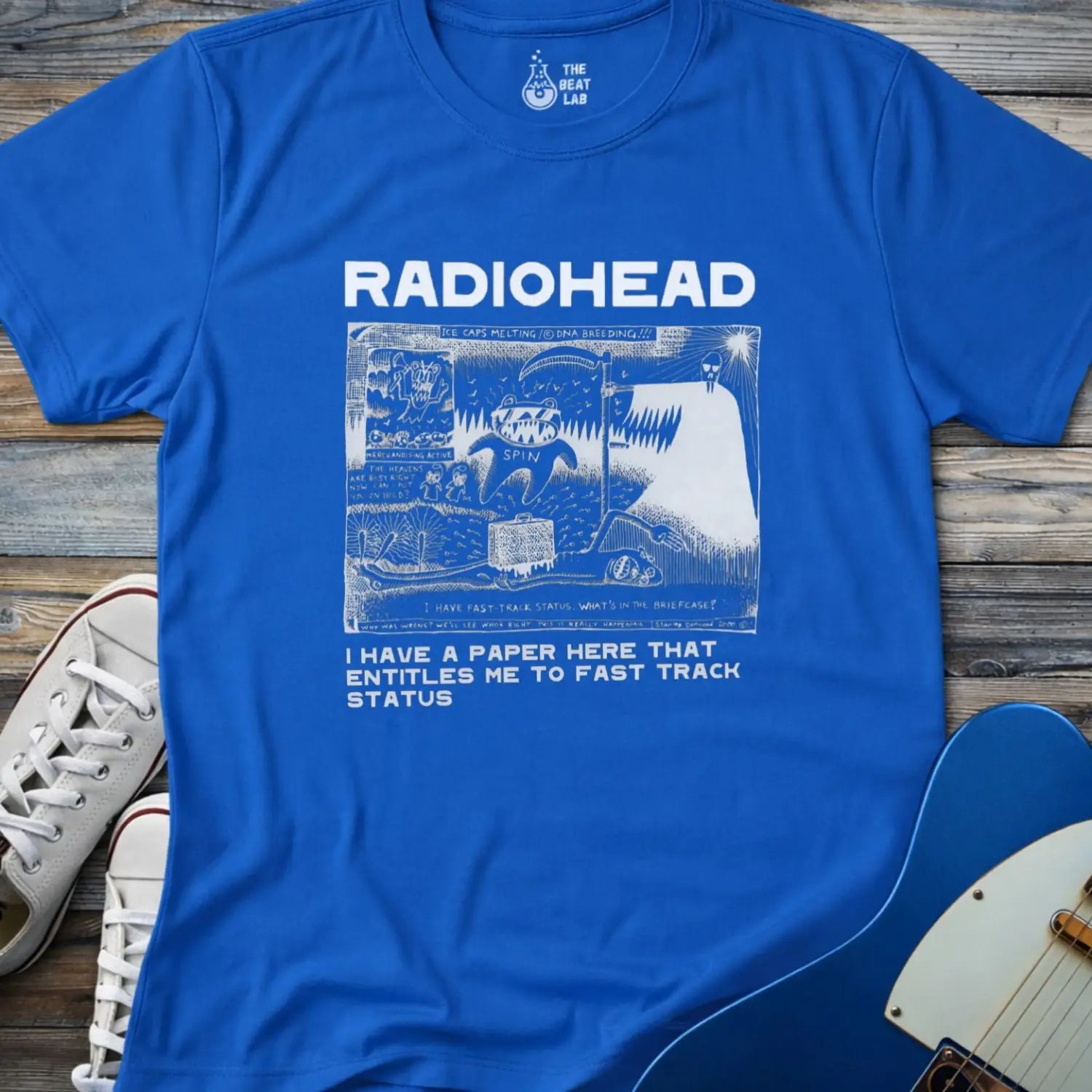 Royal blue color of adult women men gildan 64000 shirt featuring radiohead fast track comic art, vintage bandwear music shirt