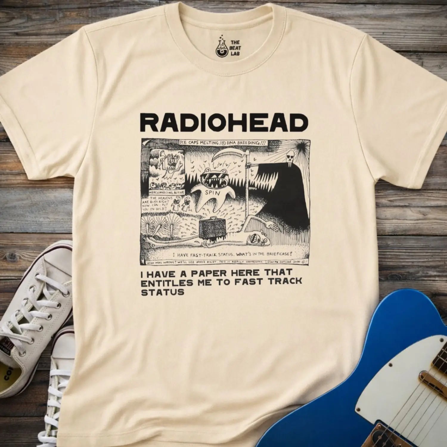 Sand beige color of adult women men gildan 64000 shirt featuring radiohead fast track comic art, vintage bandwear music shirt