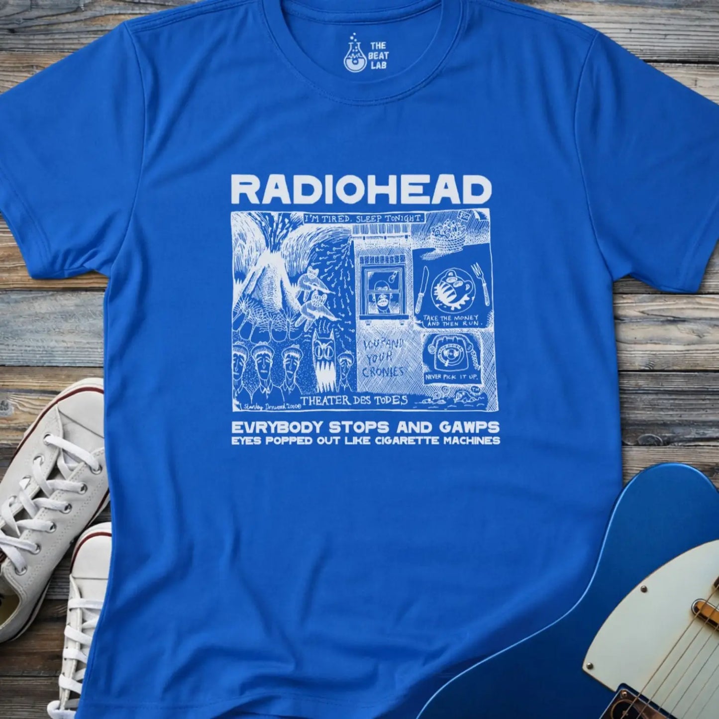Royal blue adult men women unisex shirt featuring Radiohead comic art everybody stops and gawps eyes popped out like cigarette machines, vintage band music shirt