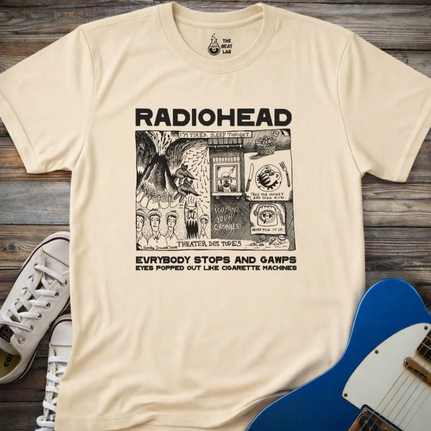 Sand beige adult men women unisex shirt featuring Radiohead comic art everybody stops and gawps eyes popped out like cigarette machines, vintage band music shirt