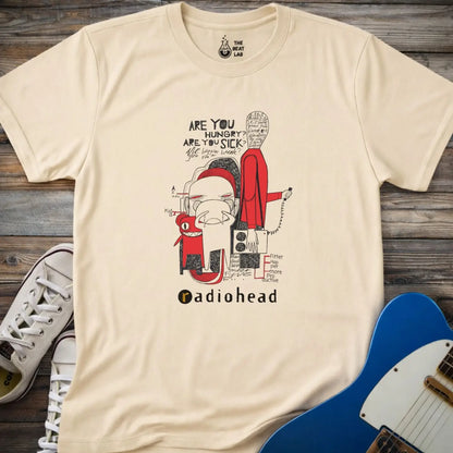 Sand cream natural color adult unisex t-shirt gildan 64000  Radiohead comic sketch t-shirt with abstract cartoon figures in red/black line art and ‘Are you hungry? Are you sick?’ text above stylized band name.