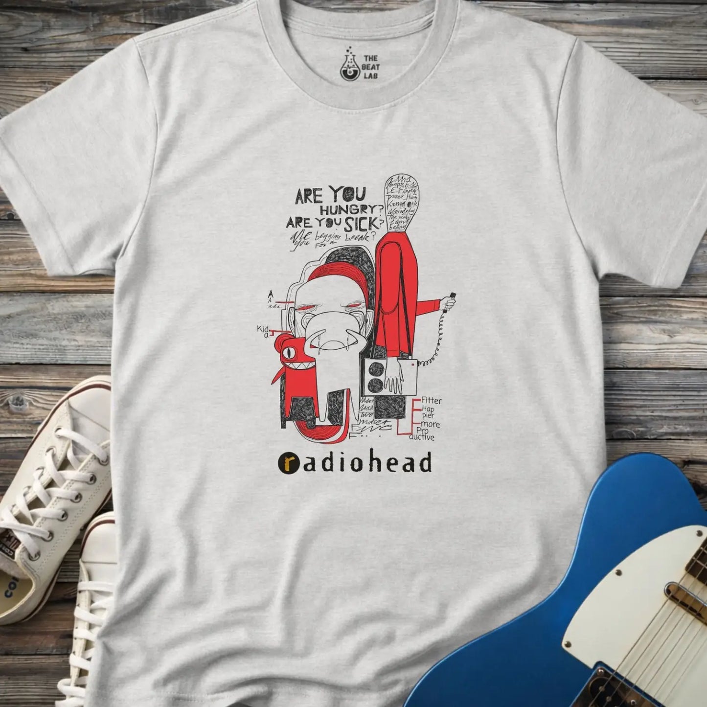 Sport grey color adult unisex t-shirt gildan 64000  Radiohead comic sketch t-shirt with abstract cartoon figures in red/black line art and ‘Are you hungry? Are you sick?’ text above stylized band name.