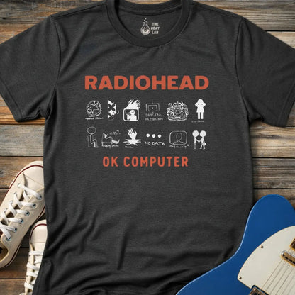 Dark heather grey color adult unisex t-shirt gildan 64000 Radiohead OK Computer graphic t-shirt with large RADIOHEAD and OK COMPUTER text and a horizontal row of minimalist white icons in between.