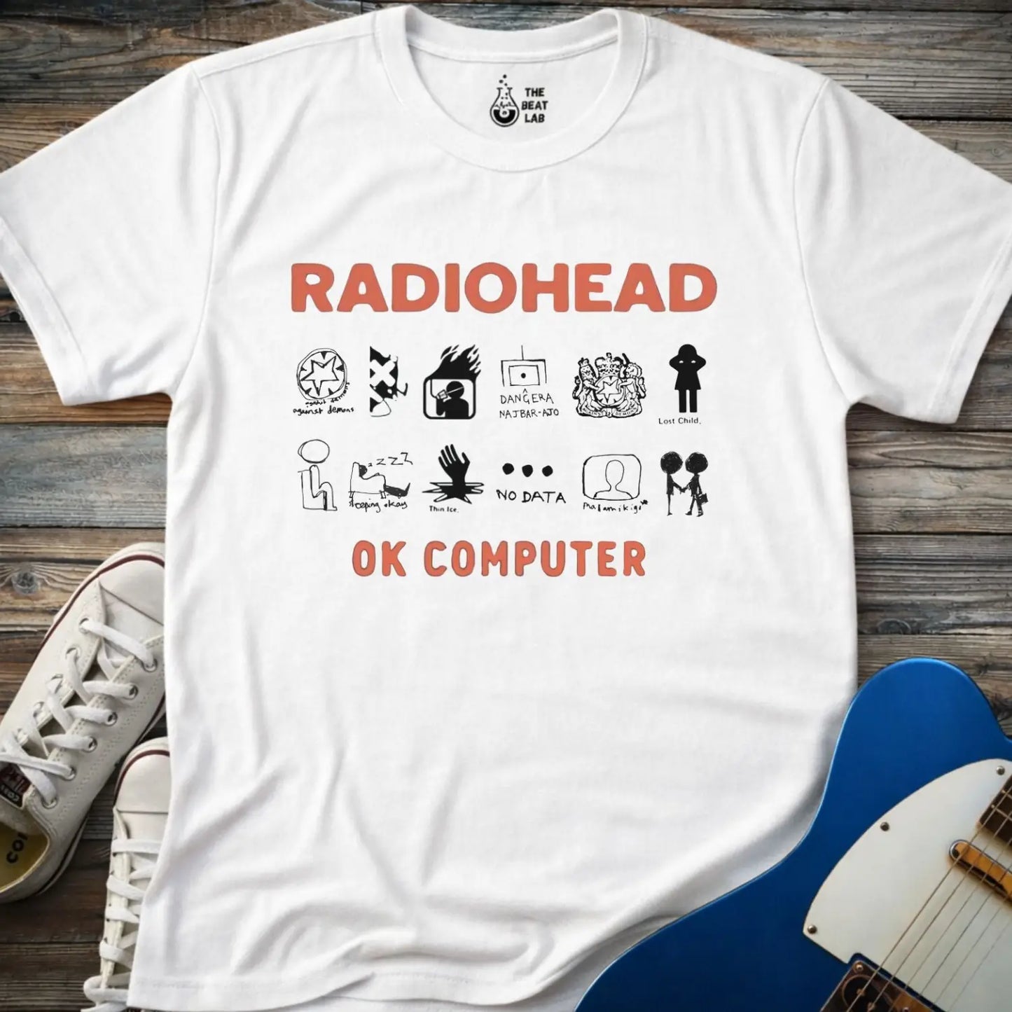 White color adult unisex t-shirt gildan 64000 Radiohead OK Computer graphic t-shirt with large RADIOHEAD and OK COMPUTER text and a horizontal row of minimalist white icons in between.