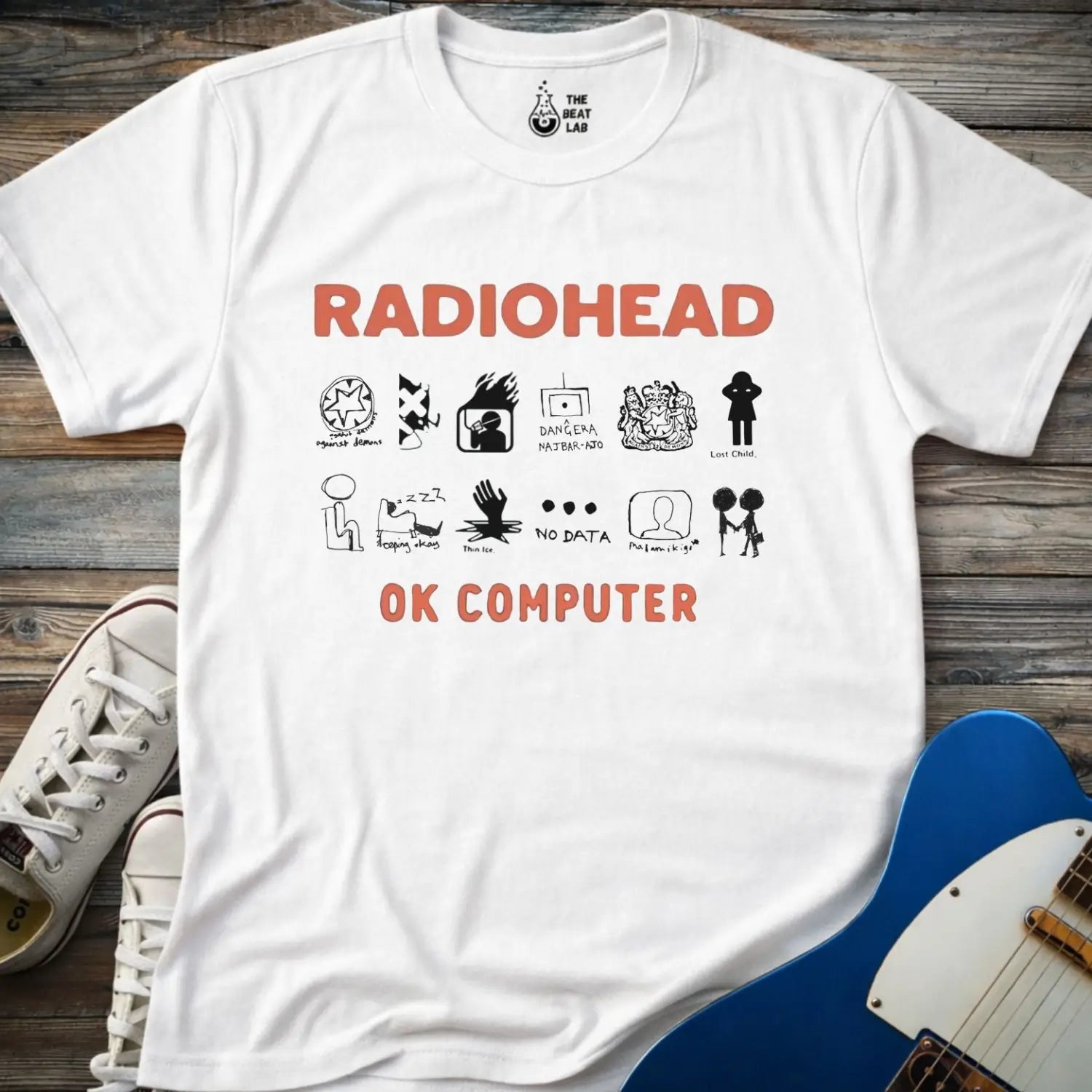 White color adult unisex t-shirt gildan 64000 Radiohead OK Computer graphic t-shirt with large RADIOHEAD and OK COMPUTER text and a horizontal row of minimalist white icons in between.