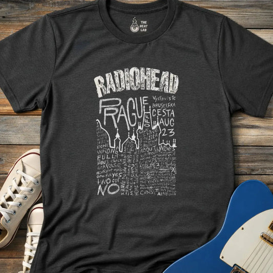 Dark Heather Grey color adult unisex t-shirt gildan 64000 Radiohead Prague concert graphic t-shirt with distressed RADIOHEAD header, large hand-drawn PRAGUE text, date details, and dense handwritten lyric-style lettering.