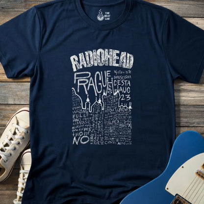 Navy blue color adult unisex t-shirt gildan 64000 Radiohead Prague concert graphic t-shirt with distressed RADIOHEAD header, large hand-drawn PRAGUE text, date details, and dense handwritten lyric-style lettering.