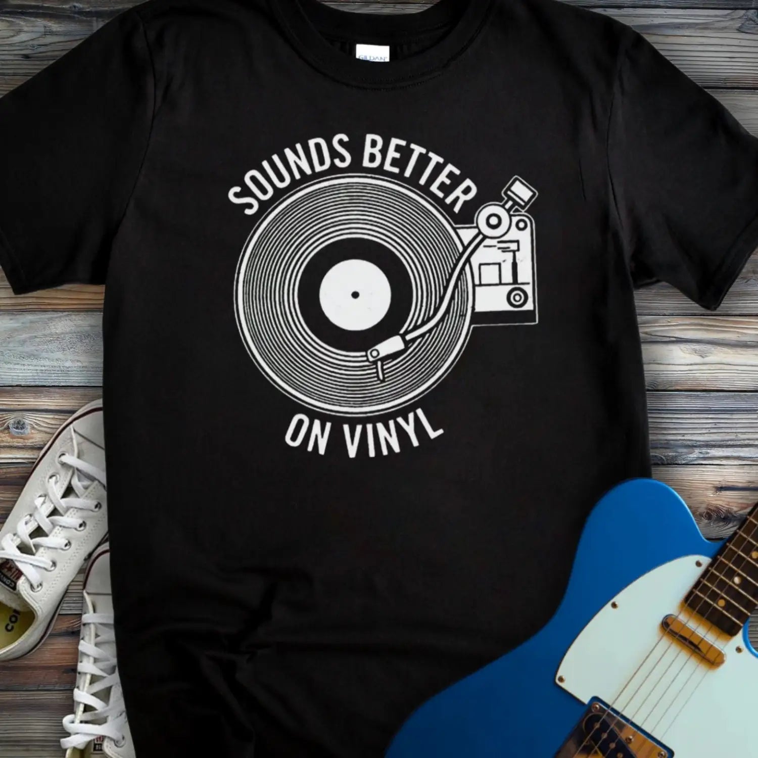 Black color of graphic t-shirt with white vinyl record player design and “Sounds Better on Vinyl” music slogan for retro music lovers.