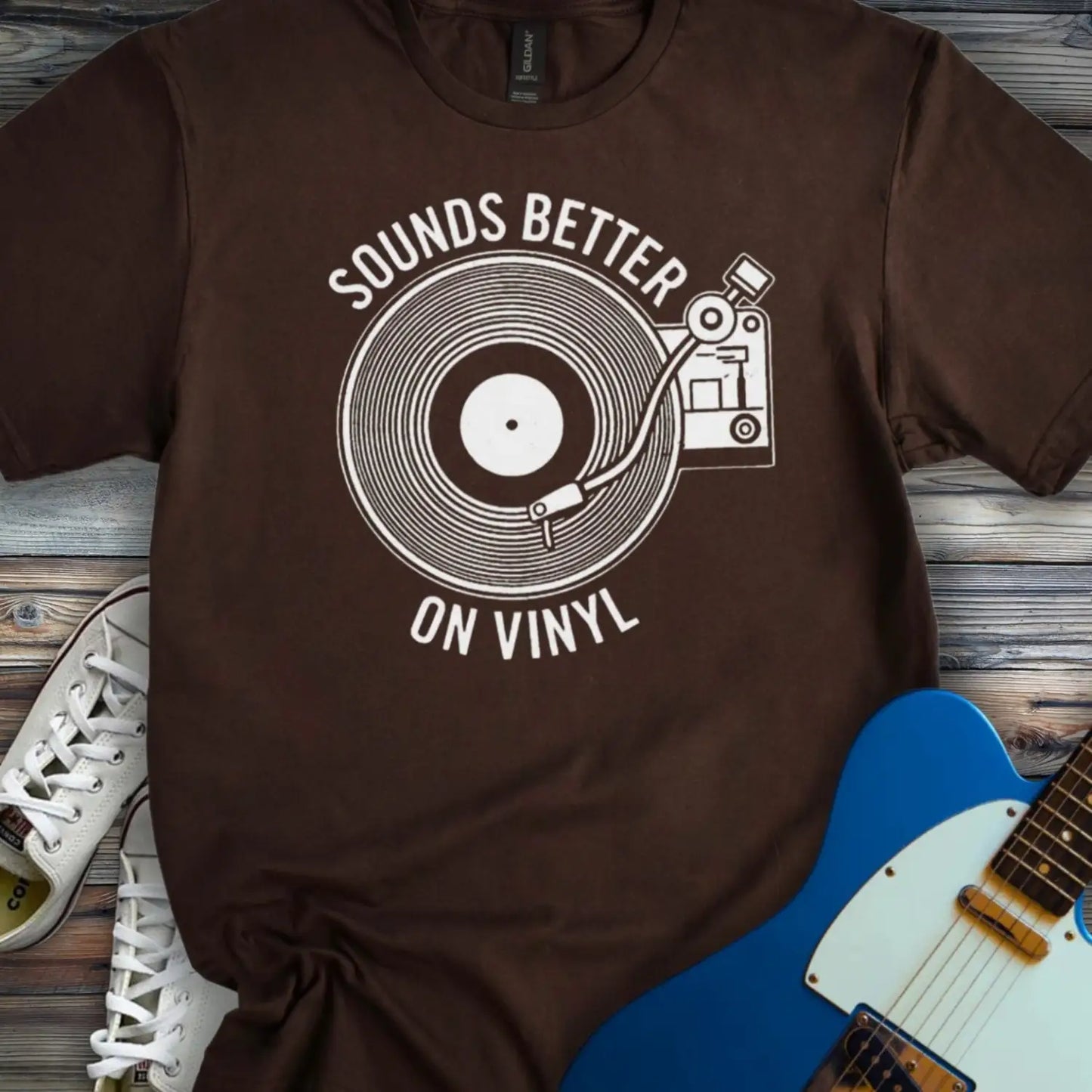 Dark Chocolate color of graphic t-shirt with white vinyl record player design and “Sounds Better on Vinyl” music slogan for retro music lovers.