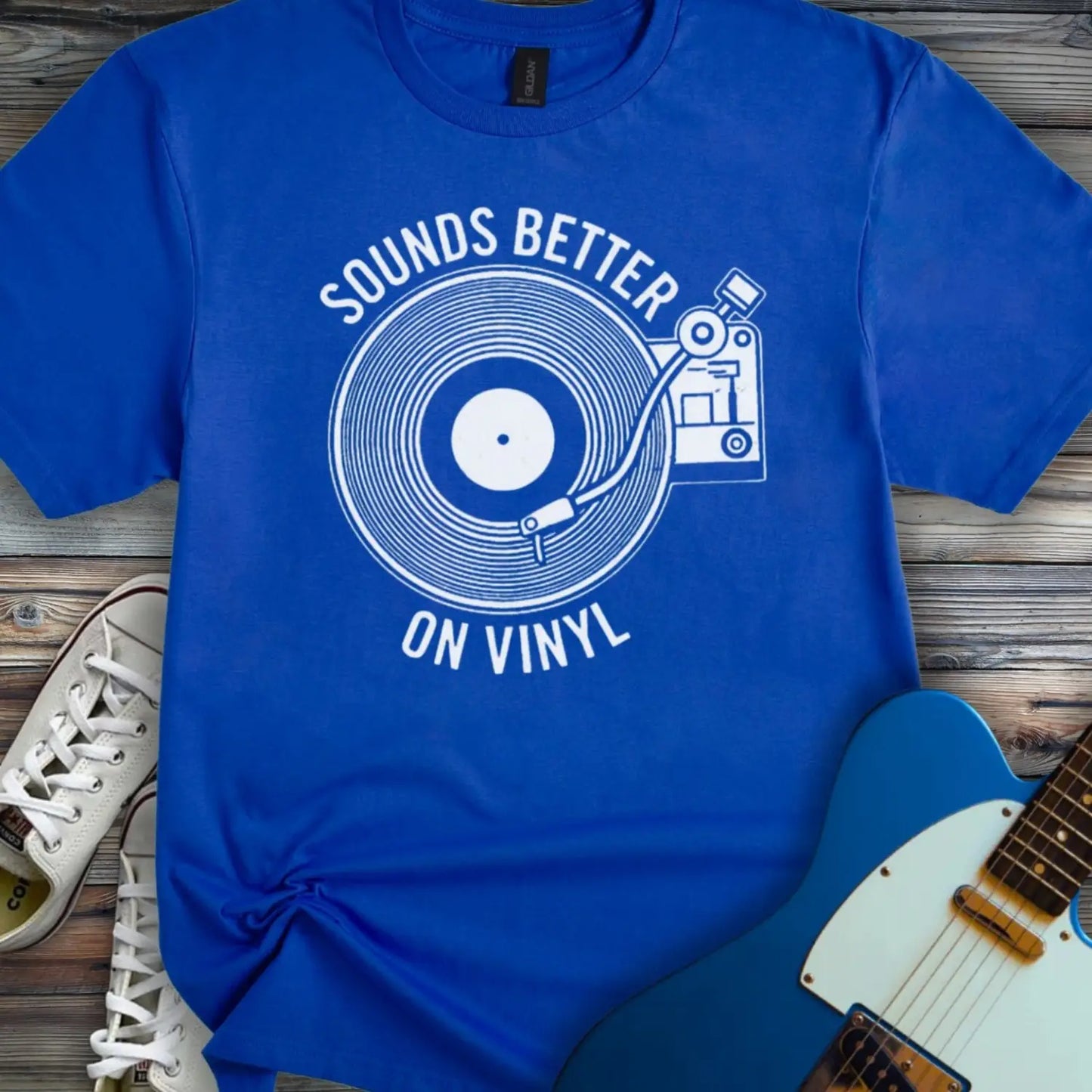 Royal blue color of graphic t-shirt with white vinyl record player design and “Sounds Better on Vinyl” music slogan for retro music lovers.