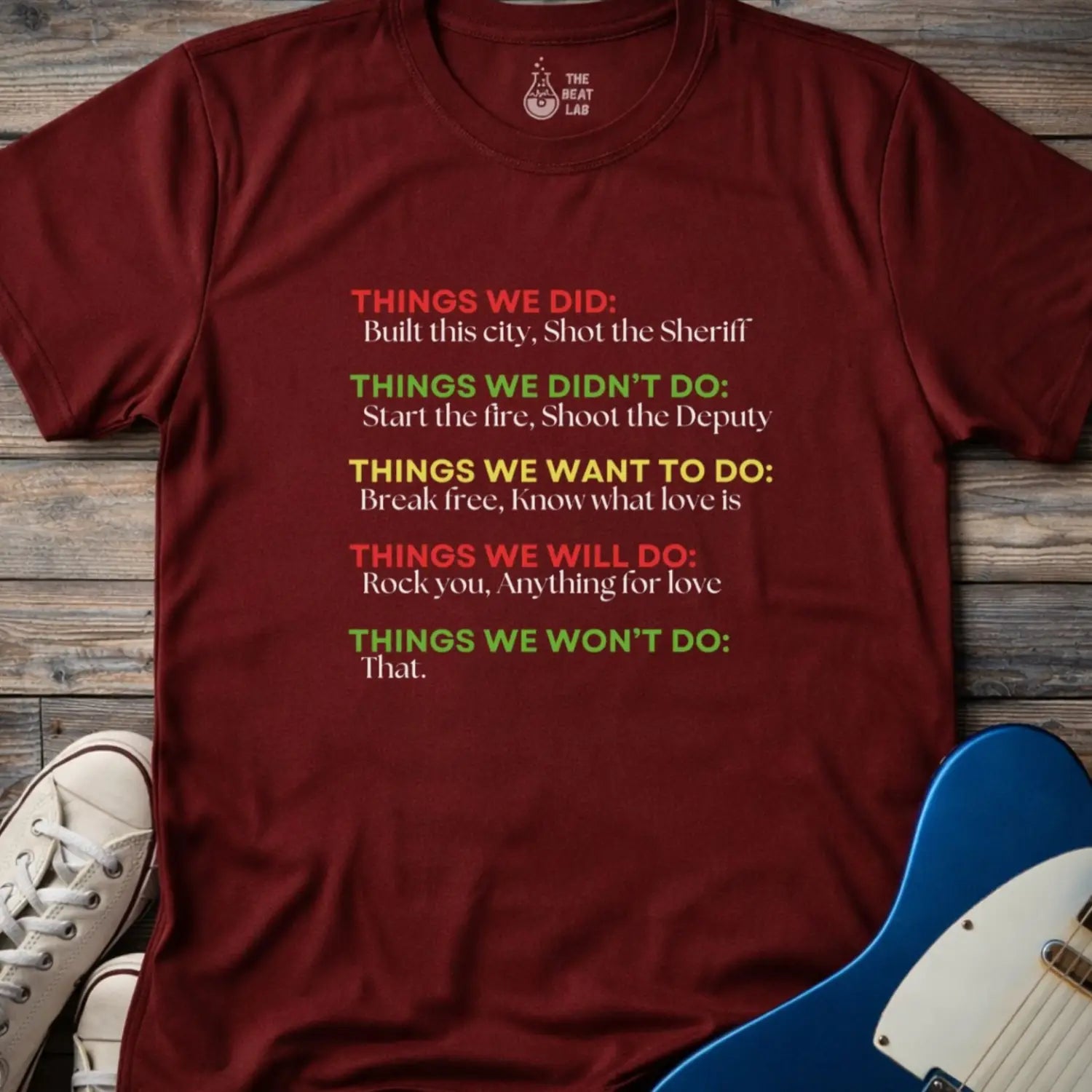 Maroon red color men women gildan 64000 shirt featuring graphic text of funny rock lyrics things we did, built this city, shot the sheriff, start the fire, shoot the deputy. Funny nostalgic rock music lyrics shirt.