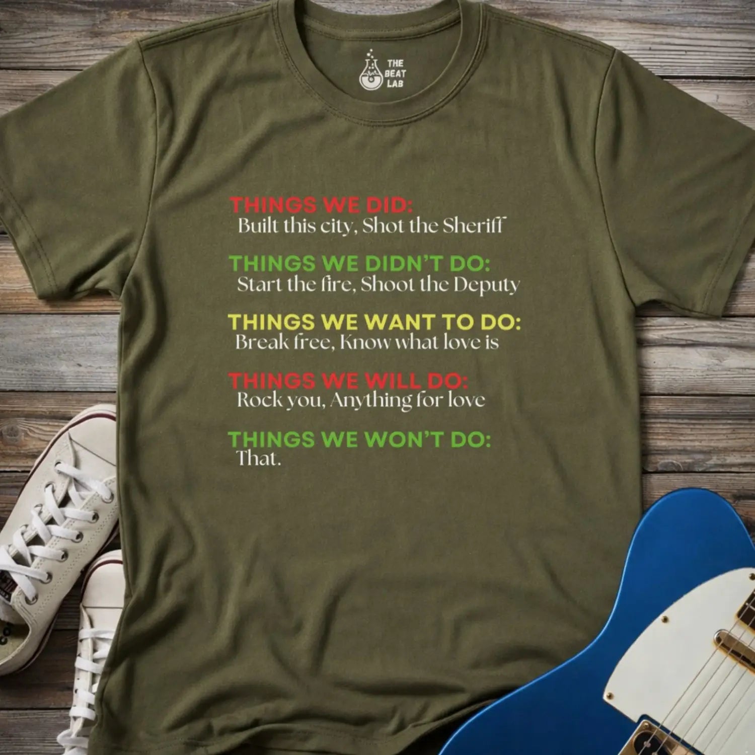 Military green color men women gildan 64000 shirt featuring graphic text of funny rock lyrics things we did, built this city, shot the sheriff, start the fire, shoot the deputy. Funny nostalgic rock music lyrics shirt.