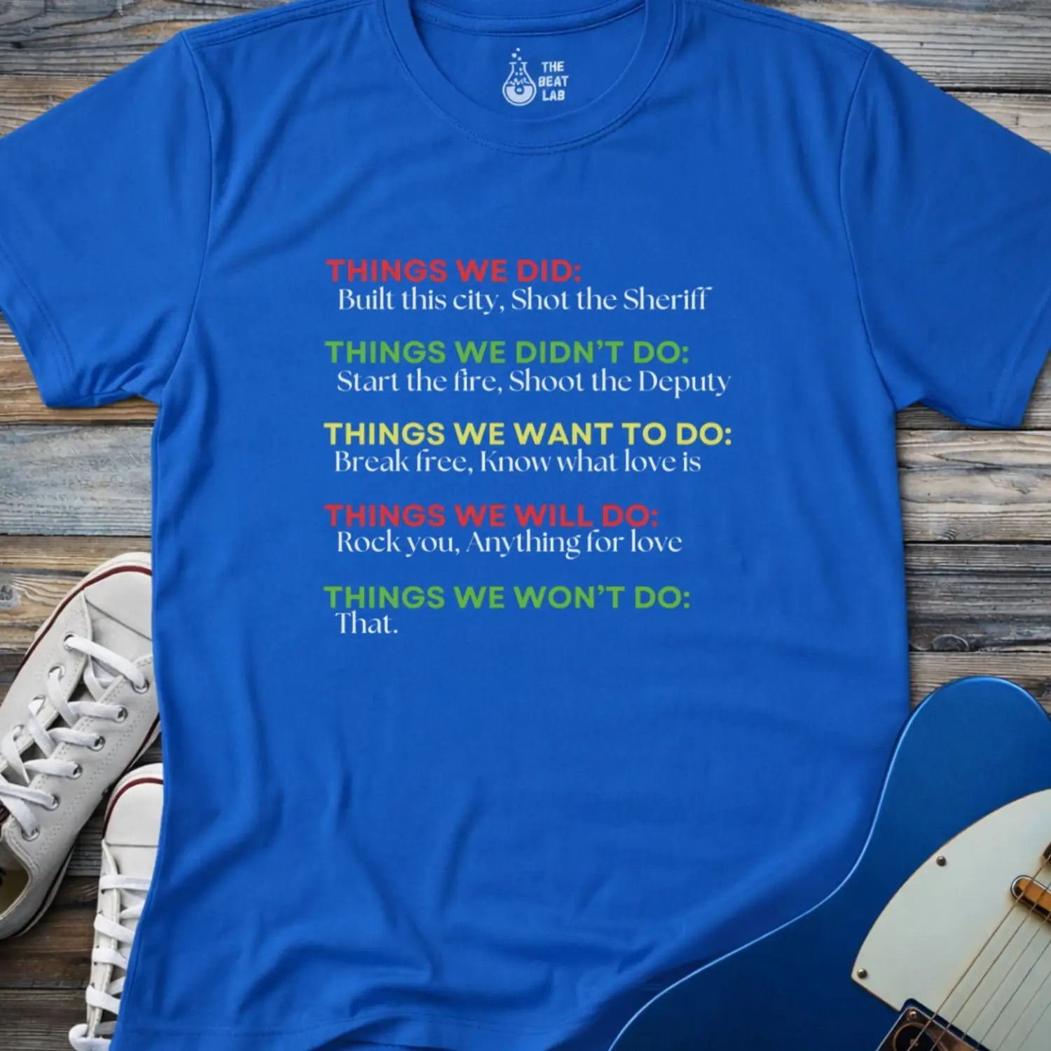 Royal blue color men women gildan 64000 shirt featuring graphic text of funny rock lyrics things we did, built this city, shot the sheriff, start the fire, shoot the deputy. Funny nostalgic rock music lyrics shirt.